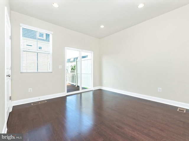 empty room featuring dark hardwood / wood-style flooring