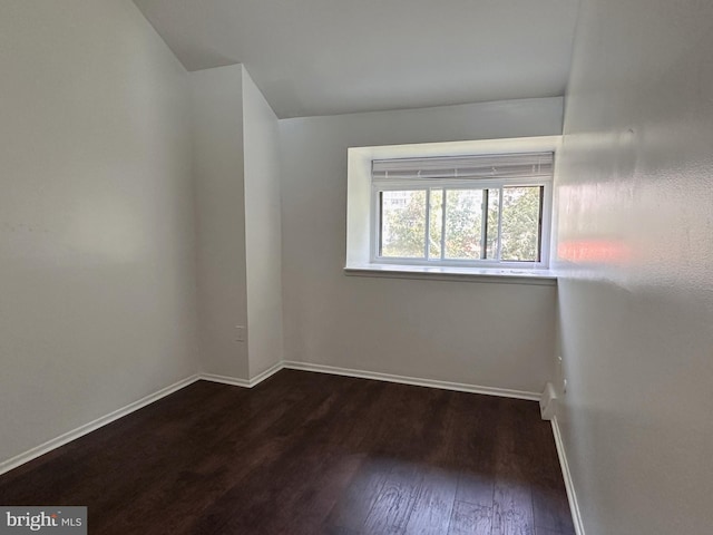 empty room featuring dark hardwood / wood-style flooring