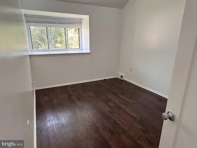 unfurnished room featuring dark hardwood / wood-style floors