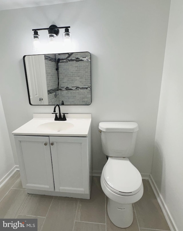 bathroom with tile patterned floors, vanity, and toilet