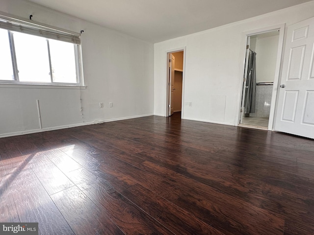 unfurnished room featuring dark wood-type flooring