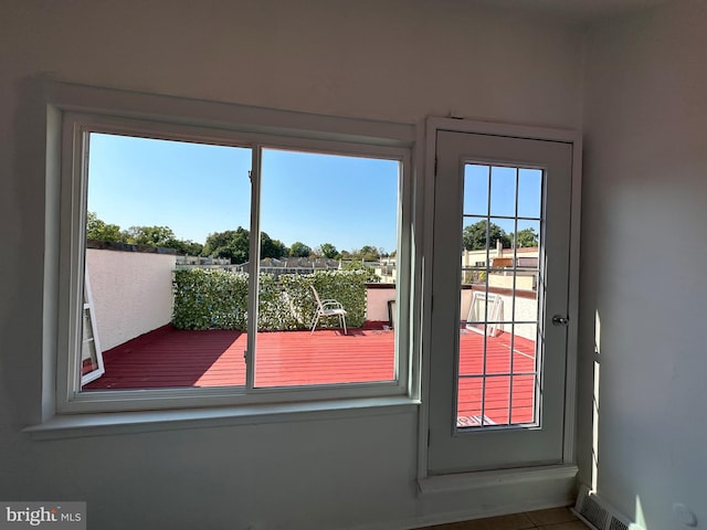 doorway to outside featuring tile patterned flooring