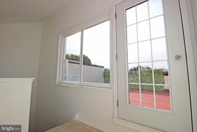 doorway featuring light tile patterned flooring