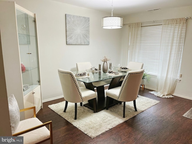 dining space featuring dark hardwood / wood-style floors