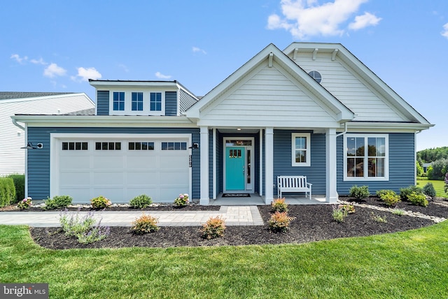 view of front of property with a front lawn, a porch, and a garage