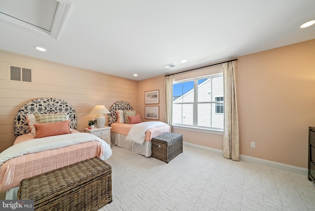 bedroom featuring wooden walls