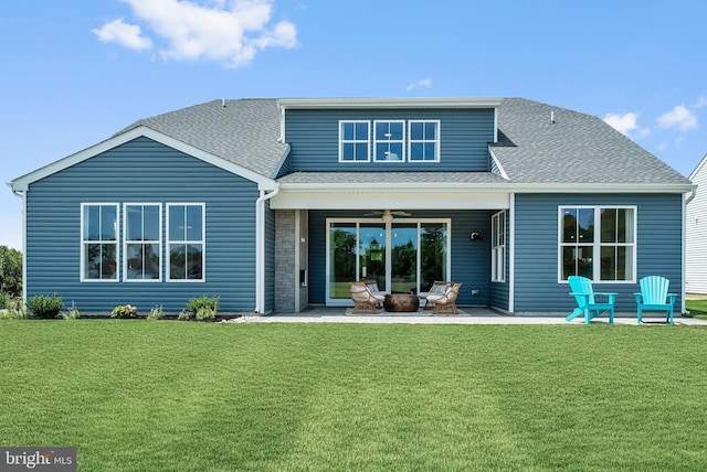 rear view of house with a lawn and a patio area