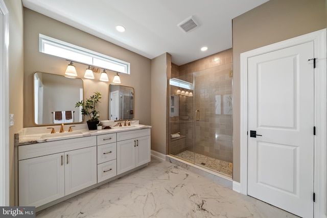 bathroom with a shower with door and vanity