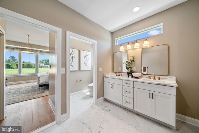 bathroom featuring wood-type flooring, vanity, and toilet