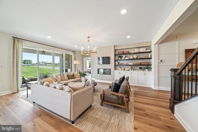 living room featuring light hardwood / wood-style floors and a notable chandelier