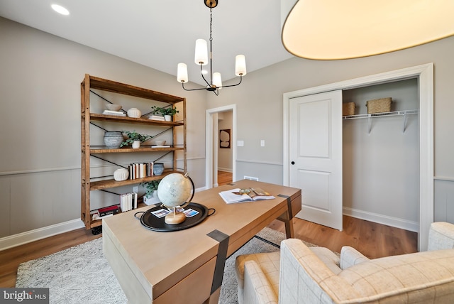 office featuring light wood-type flooring and a chandelier