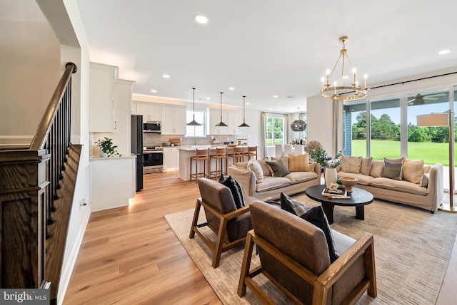 living room featuring light hardwood / wood-style flooring and a chandelier