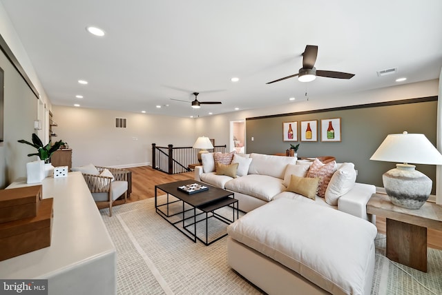 living room with ceiling fan and light wood-type flooring