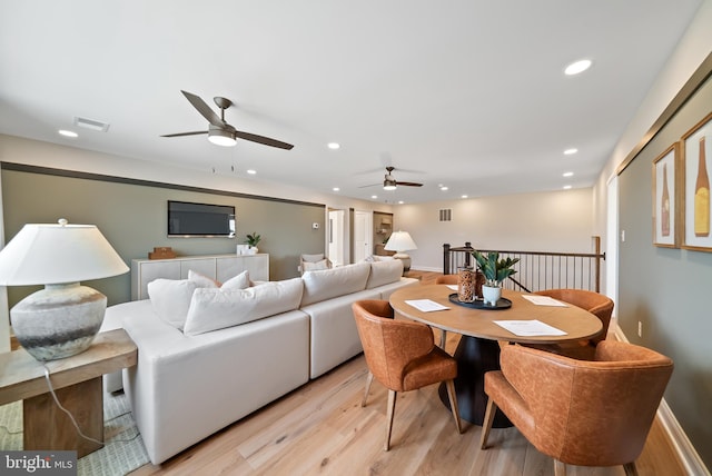 living room with light wood-type flooring and ceiling fan