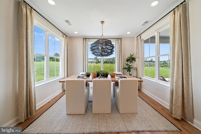 dining space featuring an inviting chandelier and light hardwood / wood-style flooring