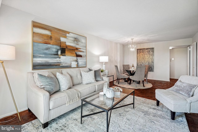 living room with wood-type flooring and a notable chandelier