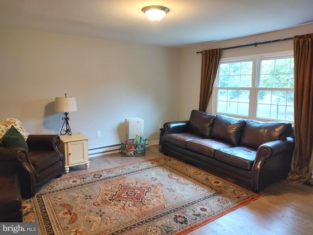 living room with hardwood / wood-style flooring and a baseboard heating unit