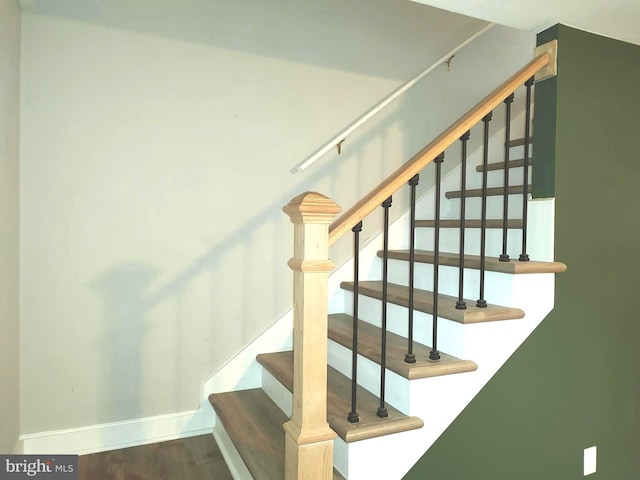 staircase with wood-type flooring