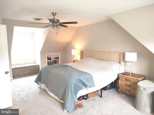 bedroom with light carpet, vaulted ceiling, and ceiling fan