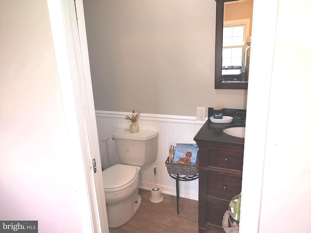 bathroom featuring hardwood / wood-style floors, vanity, and toilet