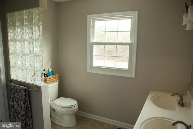 bathroom with tile patterned floors, vanity, and toilet