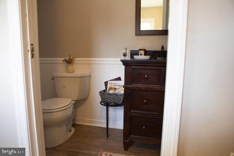 bathroom featuring wood-type flooring and toilet