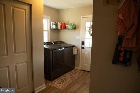 washroom with wood-type flooring and separate washer and dryer