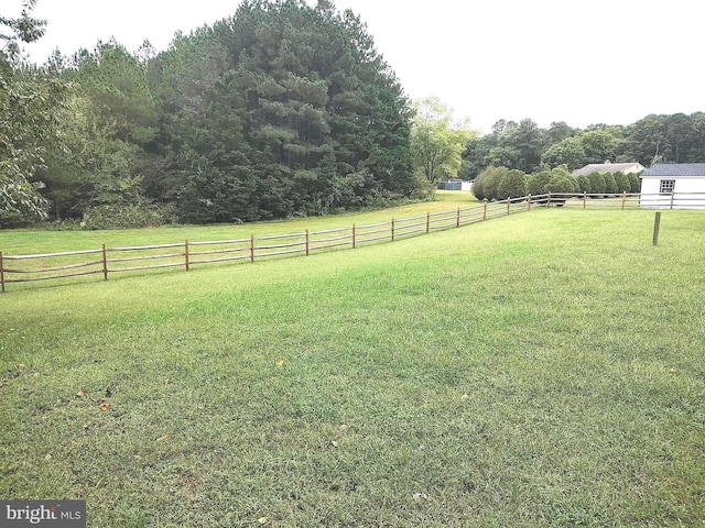 view of yard with a rural view