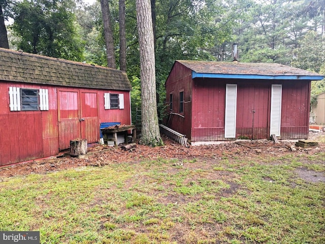 view of outbuilding with a lawn