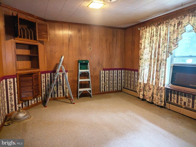 miscellaneous room featuring baseboard heating, wood walls, and carpet