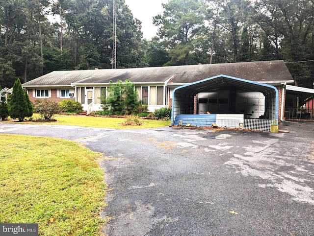 ranch-style house featuring a front lawn and a carport