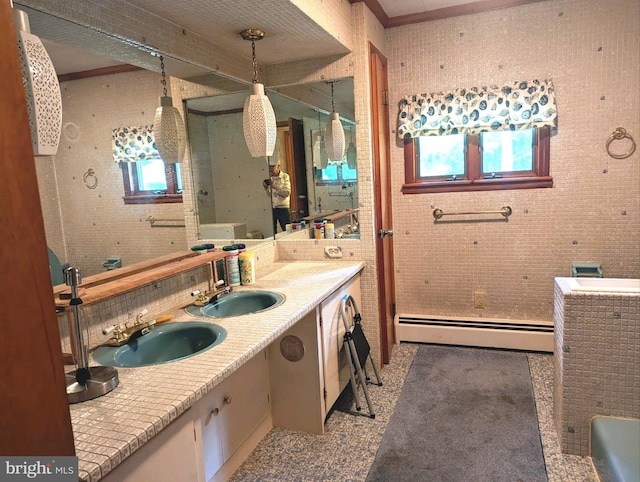 bathroom featuring baseboard heating and vanity