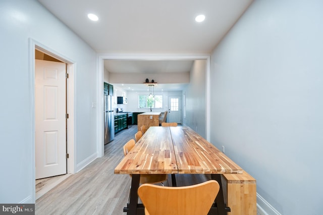 dining room featuring light hardwood / wood-style flooring and sink