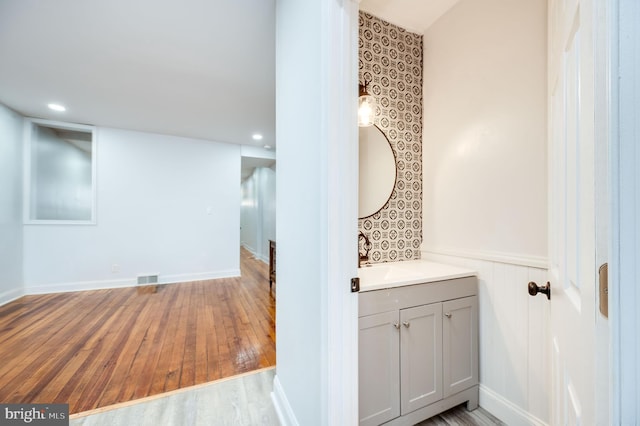 bathroom featuring vanity and hardwood / wood-style floors