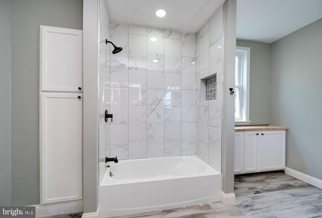 bathroom with vanity and tiled shower / bath combo