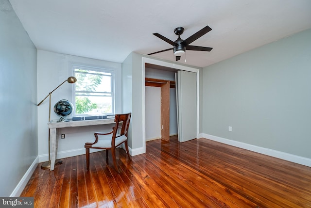 home office with ceiling fan, built in desk, and dark hardwood / wood-style flooring