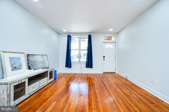 unfurnished living room featuring hardwood / wood-style floors