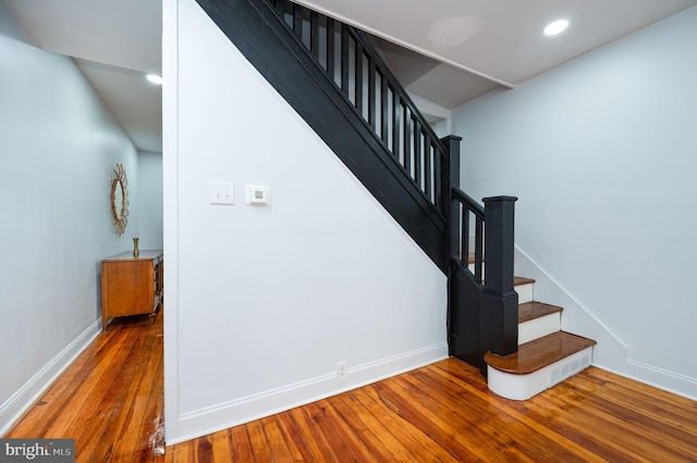 stairs with hardwood / wood-style flooring