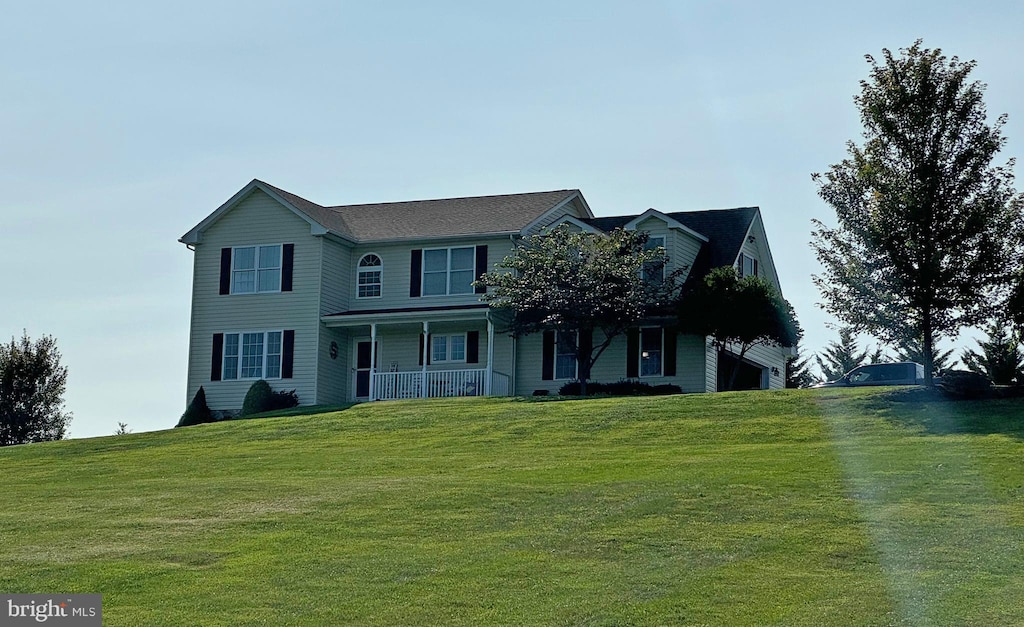 view of front of home with a front yard and covered porch