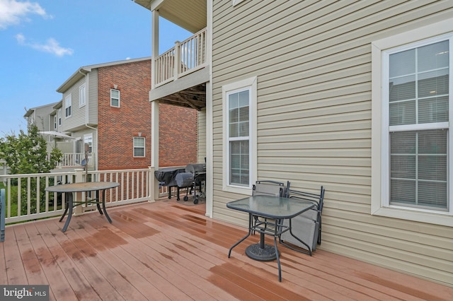 wooden terrace with a grill