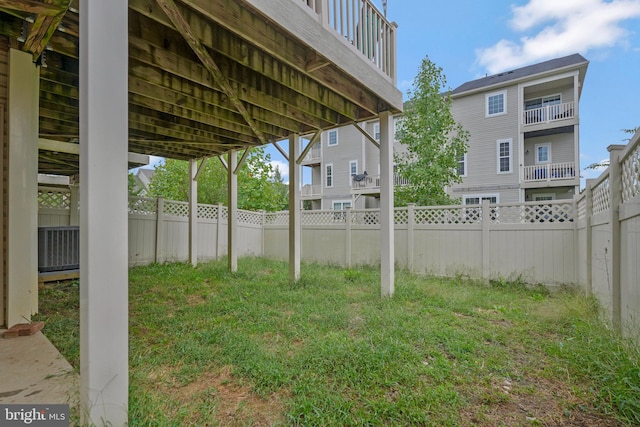 view of yard featuring a balcony and central AC