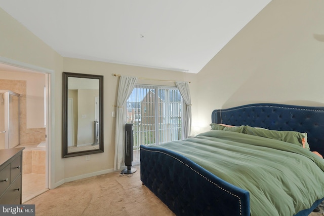 bedroom with vaulted ceiling, ensuite bath, and light carpet