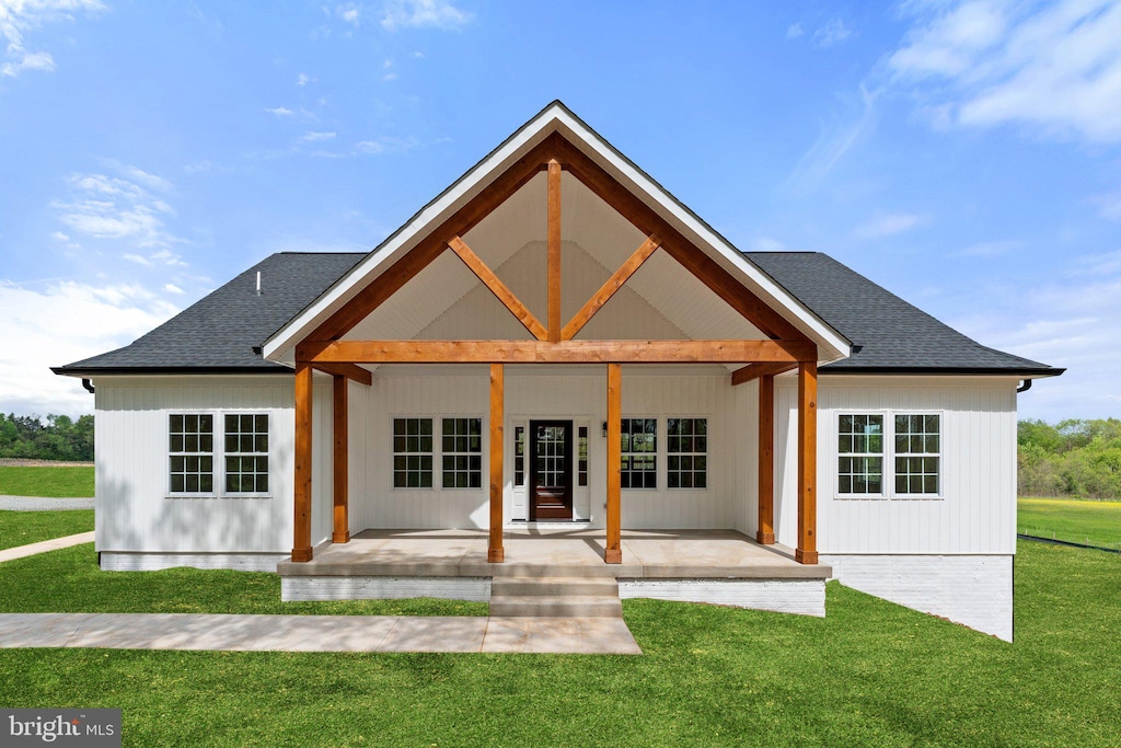 back of property featuring a patio and a yard