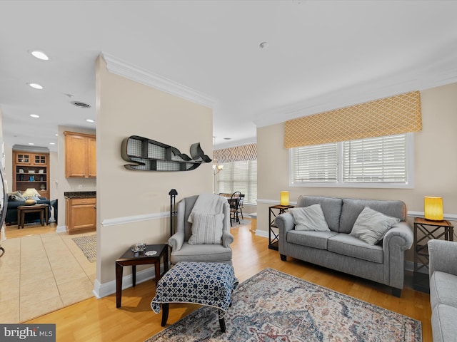 living room with light wood-type flooring and crown molding