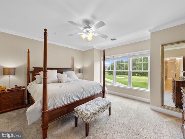 bedroom featuring ceiling fan, light colored carpet, and crown molding