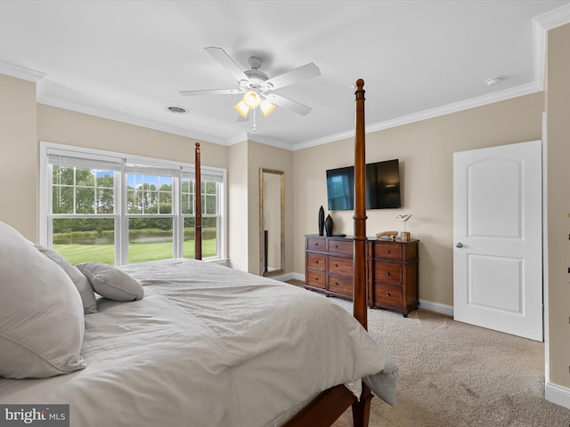 carpeted bedroom featuring ceiling fan and crown molding