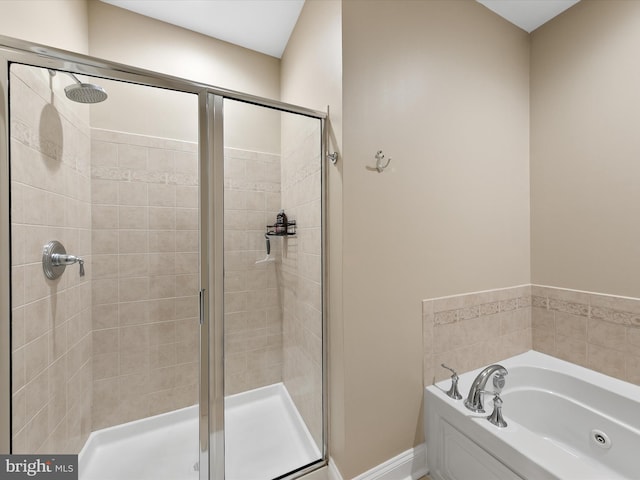 bathroom featuring separate shower and tub