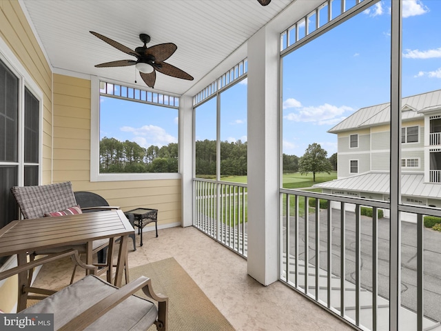 sunroom / solarium featuring ceiling fan