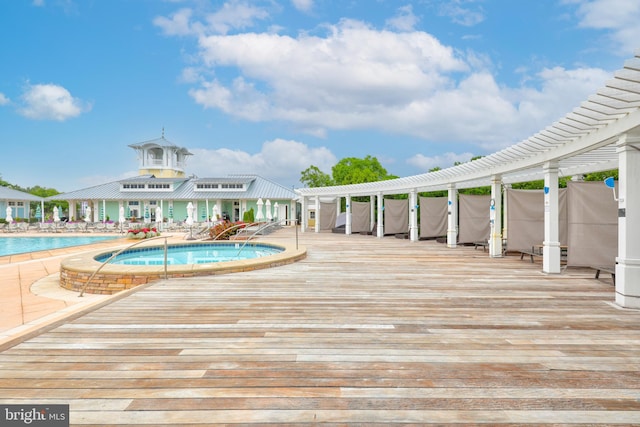 view of swimming pool with a jacuzzi