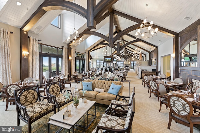 carpeted living room featuring beamed ceiling, a notable chandelier, high vaulted ceiling, and wooden ceiling